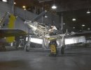 An inspector looks over a Mustang Mk I fighter.jpg